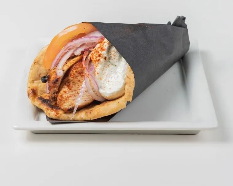 Chicken pita wrapped in black paper