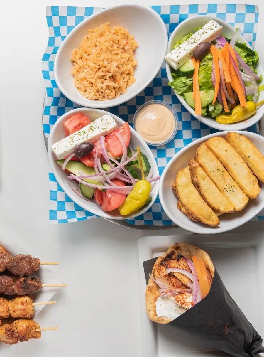 Pitas, souvlaki skewers, rice, salads and lemon potatoes to share